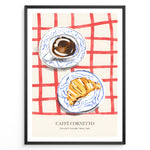 Indlæs billede til gallerivisning Italian breakfast poster with espresso and croissant on blue-patterned plates over a red checkered tablecloth, titled “Caffè Cornetto.”
