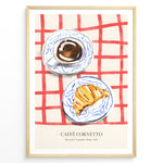 Indlæs billede til gallerivisning Italian breakfast poster with espresso and croissant on blue-patterned plates over a red checkered tablecloth, titled “Caffè Cornetto.”
