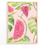 Indlæs billede til gallerivisning Watercolor poster featuring watermelon slices and tropical green leaves on a soft pink background, framed in golden.
