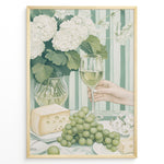 Indlæs billede til gallerivisning Elegant art print plakat of white wine glass, grapes, cheese, and hydrangeas on a green striped table with a hand holding a wine glass in a golden frame.

