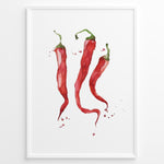 Indlæs billede til gallerivisning Watercolor plakat illustration of three red chili peppers with green stems and paint splatters, framed in black, ideal for modern kitchen or dining room décor.

