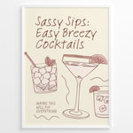 Indlæs billede til gallerivisning Minimalist cocktail-themed wall art with line drawings of martini and mojito glasses and the text “Sassy Sips: Easy Breezy Cocktails,” framed in black for kitchen or bar décor.
