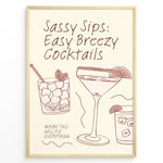 Indlæs billede til gallerivisning Minimalist cocktail-themed wall art with line drawings of martini and mojito glasses and the text “Sassy Sips: Easy Breezy Cocktails,” framed in black for kitchen or bar décor.
