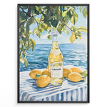 Indlæs billede til gallerivisning Limoncello art print plakat with a bottle of limoncello, lemons, and green leaves overlooking the blue sea on a striped tablecloth in a black frame.
