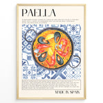 Indlæs billede til gallerivisning Watercolor paella wall art showing seafood, rice, and mussels on blue patterned tiles, framed in black, ideal for Spanish kitchen or restaurant wall decoration.
