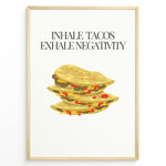 Indlæs billede til gallerivisning Funny kitchen wall art with three illustrated tacos and the quote “Inhale Tacos, Exhale Negativity,” framed in black, ideal for Mexican food lovers and modern kitchen décor.
