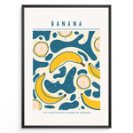 Indlæs billede til gallerivisning Colorful banana art print plakat with abstract teal and yellow shapes, text reading “Life is better with a bunch of bananas,” framed in black.
