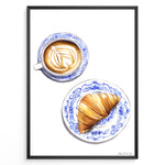 Indlæs billede til gallerivisning Art print of a cappuccino and croissant on blue patterned plates — French café-style kitchen wall décor.
