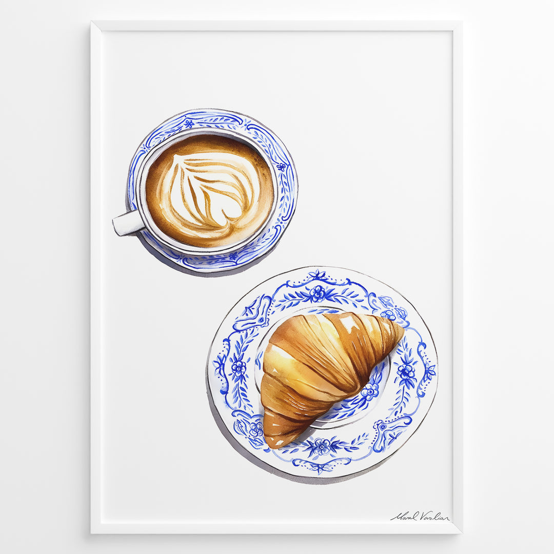 Art print of a cappuccino and croissant on blue patterned plates — French café-style kitchen wall décor.