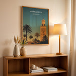 Indlæs billede til gallerivisning Marrakech Vintage Travel Plakat | Vintage Travel Poster | Denne plakat viser en stiliseret illustration af Marrakech med en høj minaret og palmetræer mod en gradienthimmel.
