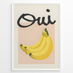 Indlæs billede til gallerivisning Modern art poster featuring the word “Oui” in bold black text above a bunch of yellow bananas on a soft pink background, framed as French kitchen wall décor.
