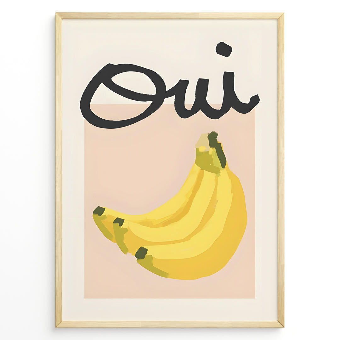 Modern art poster featuring the word “Oui” in bold black text above a bunch of yellow bananas on a soft pink background, framed as French kitchen wall décor.