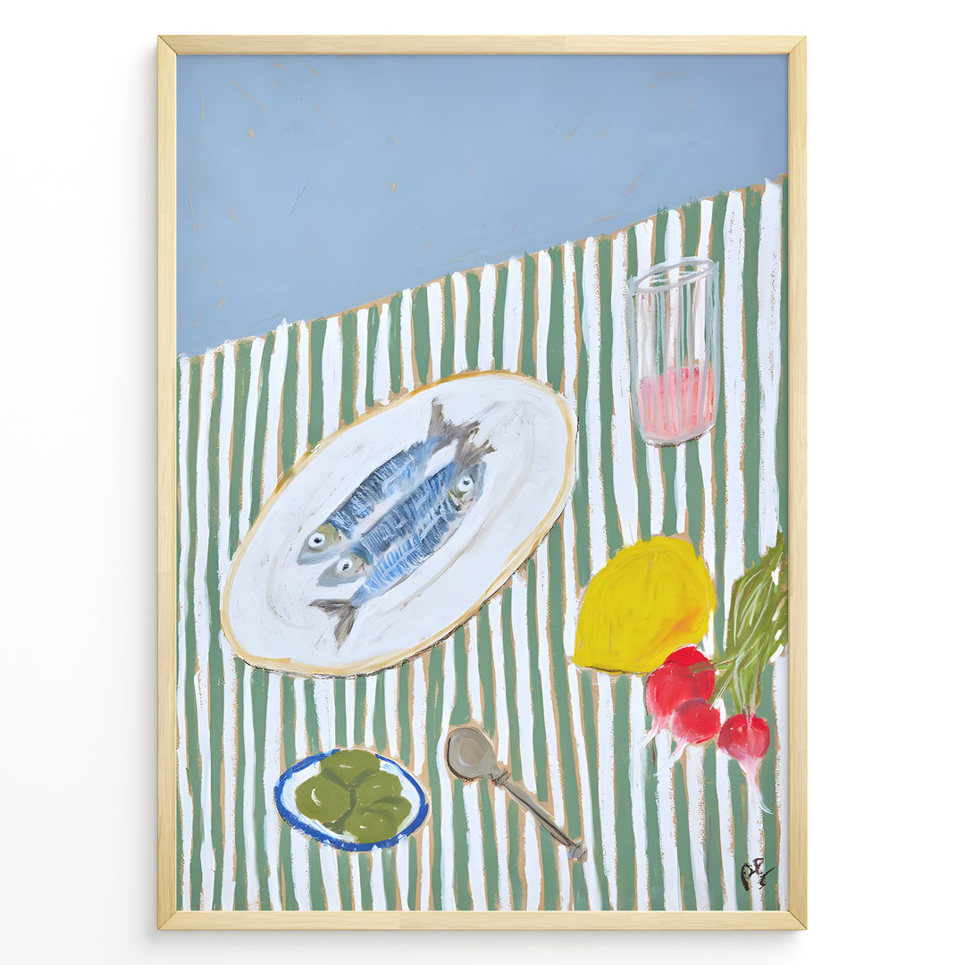 Mediterranean still life poster with fish on a white plate, lemon, radishes, olives, and a pink drink on a green and white striped tablecloth, framed as kitchen wall art.