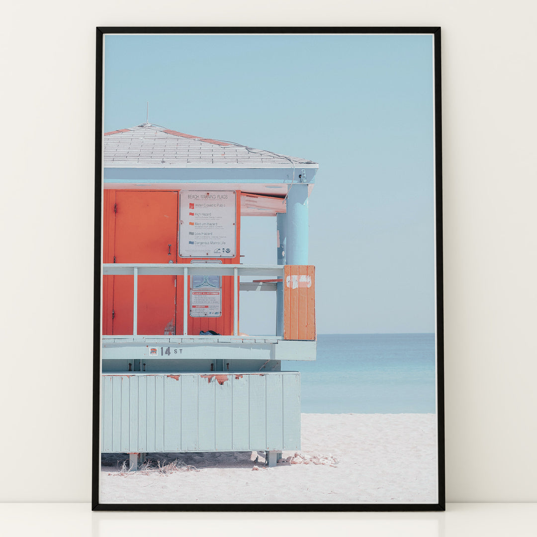 Plakat med livredders tårn | Sommer og Strand Plakater | Denne plakat viser et pastelfarvet livredders tårn med et skilt og strandadvarsler. Perfekt til strandelskere.