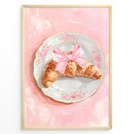 Indlæs billede til gallerivisning Illustrated croissant with a pink bow on a floral plate over a pink background.

