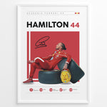 Indlæs billede til gallerivisning Framed Hamilton 44 Scuderia Ferrari F1 poster showing the driver in a red suit leaning on tires, holding a yellow helmet, with signature and career stats.
