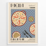 Indlæs billede til gallerivisning Vintage Spanish paella poster with illustrated pan of rice, prawns, and lemon slices on a blue patterned background in a white frame.
