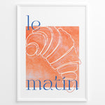 Indlæs billede til gallerivisning Le Matin poster with minimalist croissant illustration in orange and blue text on a white background in a white frame.
