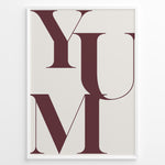 Indlæs billede til gallerivisning Minimalist typography wall art print plakat with the word “YUM” in large maroon letters on a cream background framed in black.

