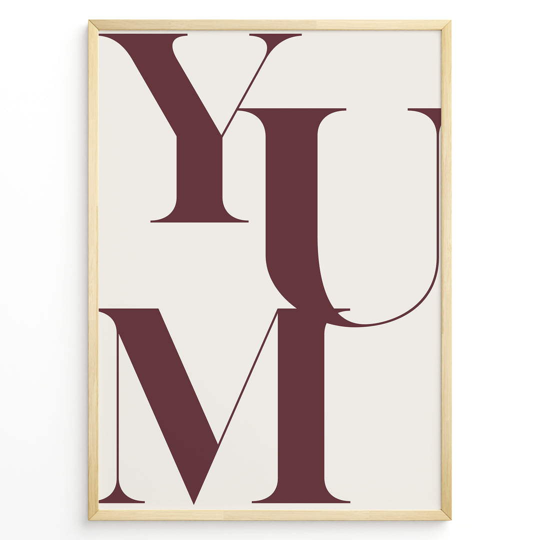 Minimalist typography wall art print plakat with the word “YUM” in large maroon letters on a cream background framed in black.