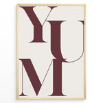Indlæs billede til gallerivisning Minimalist typography wall art print plakat with the word “YUM” in large maroon letters on a cream background framed in black.
