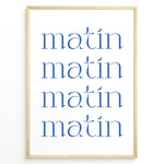 Indlæs billede til gallerivisning Minimalist French typography poster with the word “matin” repeated four times in blue text on a white background in a golden frame.
