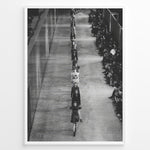 Indlæs billede til gallerivisning Fashion Plakat | Black &amp; White Fashion Runway – Editorial Wall Art Print Plakaty.dk | Black and white photograph of runway models walking in a single-file line during a fashion show, with seated spectators on one side of the runway.
