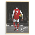 Indlæs billede til gallerivisning Poster featuring a football player in a red and white No. 7 jersey walking on a stadium field while holding a match ball, with a stylized signature at the bottom.
