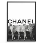 Indlæs billede til gallerivisning Fashion Plakat | CHANEL Newspaper Bench – Fashion Art Poster Plakaty.dk | Black and white fashion poster of four women sitting on a bench reading newspapers, with the bold text &quot;CHANEL&quot; across the top half of the image.

