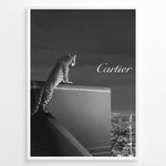 Indlæs billede til gallerivisning Fashion Plakat | Cartier Panther Over the City: Iconic Elegance in Monochrome Plakaty.dk | Black and white image of a panther perched on a Cartier box overlooking a city skyline at night, with the Cartier logo in the sky.

