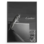 Indlæs billede til gallerivisning Fashion Plakat | Cartier Panther Over the City: Iconic Elegance in Monochrome Plakaty.dk | Black and white image of a panther perched on a Cartier box overlooking a city skyline at night, with the Cartier logo in the sky.

