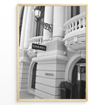 Indlæs billede til gallerivisning Fashion Plakat | Chanel Boutique Exterior – Monte Carlo, Monaco Plakaty.dk | Black and white photo of the Chanel storefront in Monte Carlo, Monaco, showcasing ornate architecture with columns, balconies, and a hanging sign.
