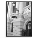 Indlæs billede til gallerivisning Fashion Plakat | Chanel Boutique Exterior – Monte Carlo, Monaco Plakaty.dk | Black and white photo of the Chanel storefront in Monte Carlo, Monaco, showcasing ornate architecture with columns, balconies, and a hanging sign.
