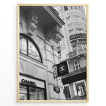 Indlæs billede til gallerivisning Fashion Plakat | Chanel Boutique Vienna Black &amp; White Architectural Poster Plakaty.dk | Black and white photo of a Chanel store in a European city with ornate architecture and a Chanel flag sign.
