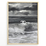 Indlæs billede til gallerivisning Fashion Plakat | Chanel Ocean Wave Black &amp; White Fashion Poster Plakaty.dk | Black and white ocean wave poster with the Chanel logo centered over crashing waves and a stormy sky.
