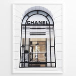 Indlæs billede til gallerivisning Fashion Plakat | Chanel Storefront Window – Fashion Photography Print Plakaty.dk | Photograph of a Chanel boutique storefront window with elegant black framing and luxury fashion items on display.
