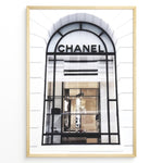 Indlæs billede til gallerivisning Fashion Plakat | Chanel Storefront Window – Fashion Photography Print Plakaty.dk | Photograph of a Chanel boutique storefront window with elegant black framing and luxury fashion items on display.

