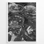 Indlæs billede til gallerivisning Fashion Plakat | Cheers in Black &amp; White: Luxe Champagne Coupes Wall Art Plakaty.dk | Black and white photo of multiple champagne coupe glasses being raised in a celebratory toast, reflecting light and bubbles.
