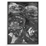 Indlæs billede til gallerivisning Fashion Plakat | Cheers in Black &amp; White: Luxe Champagne Coupes Wall Art Plakaty.dk | Black and white photo of multiple champagne coupe glasses being raised in a celebratory toast, reflecting light and bubbles.
