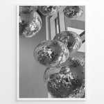 Indlæs billede til gallerivisning Fashion Plakat | Cluster of Disco Balls in Natural Light Plakaty.dk | Black and white photo of multiple hanging disco balls reflecting natural light near large windows
