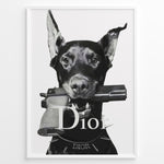 Indlæs billede til gallerivisning Fashion Plakat | Dior Guard Dog – Bold Fashion Art Print Plakaty.dk | Black and white image of a Doberman dog holding a handgun in its mouth, wearing a spiked collar with the Dior logo, against a plain background.
