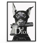 Indlæs billede til gallerivisning Fashion Plakat | Dior Guard Dog – Bold Fashion Art Print Plakaty.dk | Black and white image of a Doberman dog holding a handgun in its mouth, wearing a spiked collar with the Dior logo, against a plain background.
