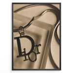 Indlæs billede til gallerivisning Fashion Plakat | Dior Sepia Necklace Charm – Vintage-Inspired Fashion Wall Art Plakaty.dk | Sepia-toned Dior necklace charm with close-up detail on a textured surface, styled as vintage fashion wall art.
