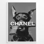 Indlæs billede til gallerivisning Fashion Plakat | Edgy Chanel-Inspired Art Featuring Dog with Gun Plakaty.dk | Black dog with spiked collar holding a handgun in its mouth, with the word &quot;CHANEL&quot; overlaid in bold white text.
