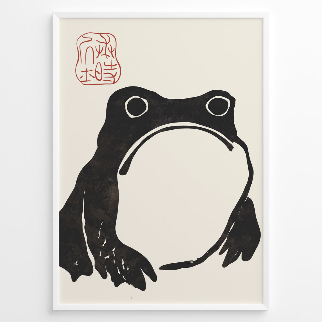 Framed Japanese ink art poster featuring a minimalist black frog illustration with red calligraphy stamp on a beige background.