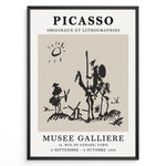 Indlæs billede til gallerivisning Framed Picasso Don Quixote art poster with minimalist black sketch of riders and windmills on a beige background.
