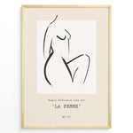 Indlæs billede til gallerivisning Framed La Femme poster featuring minimalist female silhouette line art in black on a beige background with modern typography.
