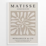 Indlæs billede til gallerivisning Framed Matisse Papiers Découpés poster with abstract beige cut-out shapes and black typography on a neutral background.
