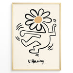 Indlæs billede til gallerivisning Framed Keith Haring-style poster showing a black outlined dancing figure with a daisy flower head on a beige background.
