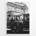 Indlæs billede til gallerivisning Fashion Plakat | Luxury Lifestyle: Mercedes G-Wagon x Prada Milano Wall Art Plakaty.dk | Black and white framed photo of a Mercedes G-Wagon with Prada Milano text overlay, parked in front of ornate historic buildings.
